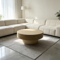 Table basse moderne en bois avec piétement doré champagne, plateau texturé aspect pierre, table centrale circulaire pour salon