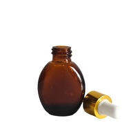 Bouteille en verre ambré de forme ovale de 10ml 20ml 30ml 50ml Contenant en verre ambré pour les soins de la peau Bouteille cosmétique pour huiles essentielles