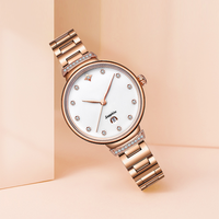 Montre à quartz pour femme, luxe moderne, directement de l'usine, avec verre, bracelet en acier inoxydable, lunette sertie de diamants, aiguilles en forme de feuille, date et fermoir papillon