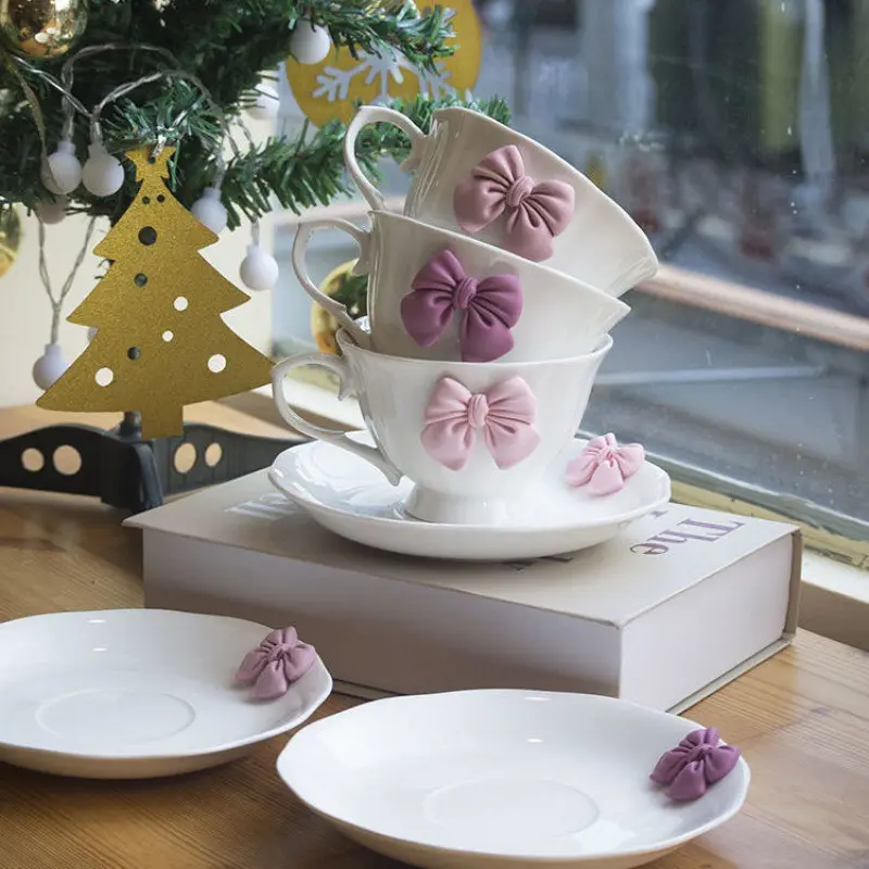 Solhui Wholesale elegant ceramic water/tea cup with pink bow decoration Nordic coffee cup with saucer