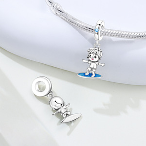 Un colgante pequeño, único y sofisticado con un niño montado en una tabla de surf; un accesorio de pulsera/joyería DIY para mujer. - Product Image 6