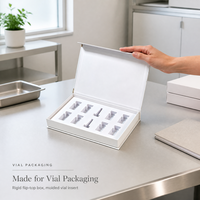 Boîte cadeau rigide en forme de livre magnétique blanche personnalisée avec insert en mousse EVA à 10 cavités pour l'emballage d'échantillons cosmétiques en flacon en verre