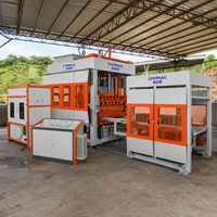 Machine de fabrication de blocs de béton entièrement automatique QT9-15S contrôlée par PLC, pour blocs creux, pleins, pavés, briques autobloquantes et bordures.