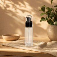 Emballage cosmétique professionnel en verre, flacon cylindrique transparent avec bouchon pompe noir pour lotion, sérum, fond de teint