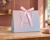 Sacs cadeaux en papier pastel avec nœuds en ruban et poignées en corde, dégradé rose et bleu, pour mariages, baby showers et anniversaires