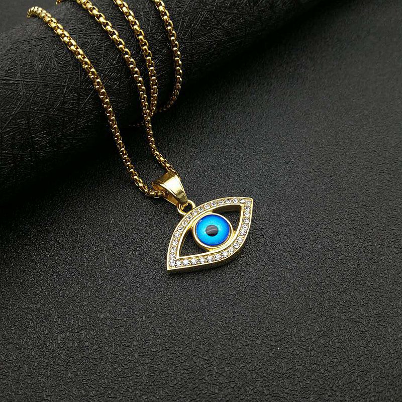 Petit pendentif unique doré aux yeux bleus