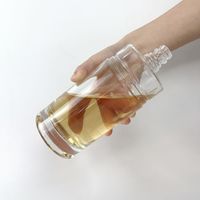 Bouteille à liqueur en verre lourd de forme cylindrique classique, design concave et rond, avec bouchon à vis