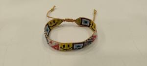 Bracelet artisanal Sstringz en perles Miyuki Delica multicolores avec motif visage souriant jaune, motif œil bleu et motif à carreaux noir et blanc - Product Image 5