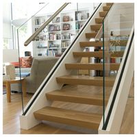Escalier flottant moderne Prima avec poutre en acier au carbone et garde-corps en verre pour villa