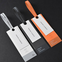 Étiquettes personnalisées en PVC souple de haute qualité, impression en caoutchouc, vente en gros, étiquettes suspendues pour vêtements en papier spécial incolore gaufré