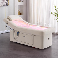 Table de massage électrique moderne personnalisée avec revêtement en cuir PU et fonction chauffante pour les soins de spa en hôtel