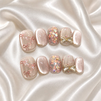 Faux ongles autocollants œil de chat courts et ronds rose nude, avec nœud papillon peint à la main et strass, vente en gros pour femmes