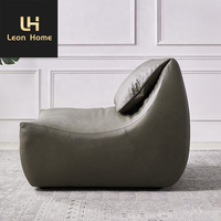Mobilier de salon italien moderne et léger et luxueux Chaise longue de loisirs en cuir avec repose-pieds