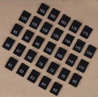 Étiquettes de taille tissées pliées haute densité pour la vente immédiate en stock