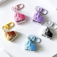 Porte-clés mini piano à queue en résine dégradée, breloque instrument de musique gaufrée avec note musicale, accessoire de sac pour les amateurs de musique