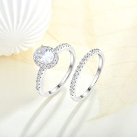 Fournisseur de bijoux haut de gamme QX, bague en or fin et argent sterling 925 avec pierre principale en forme de poire sertie d'un halo et de deux rangées de pierres fines