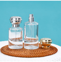 Flacon de parfum cylindrique de luxe en verre 55ML, fond en forme de montagne avec couvercle rond en forme de fleur or et argent