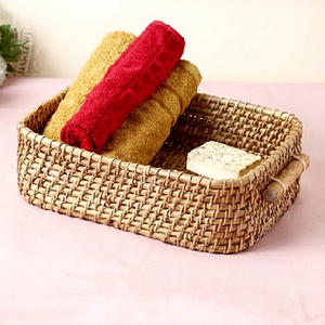 Shallow woven rattan countertop basket with wooden <b>side</b> handles for bathroom towels, available at wholesale prices. - Product Image 1