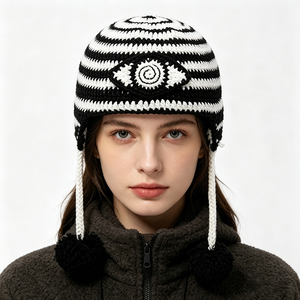Bonnet à oreilles en crochet noir et blanc, bonnet tricoté fait main avec pompons et motif œil porte-bonheur, bonnet chaud d'hiver pour le ski et le streetwear - Product Image 1