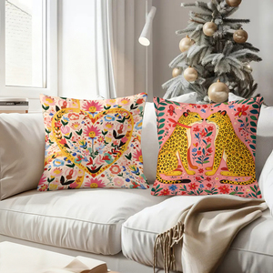 Vibrant floral and animal themed throw pillows decorate cozy living room sofa with festive holiday stockings in background - Product Image 4