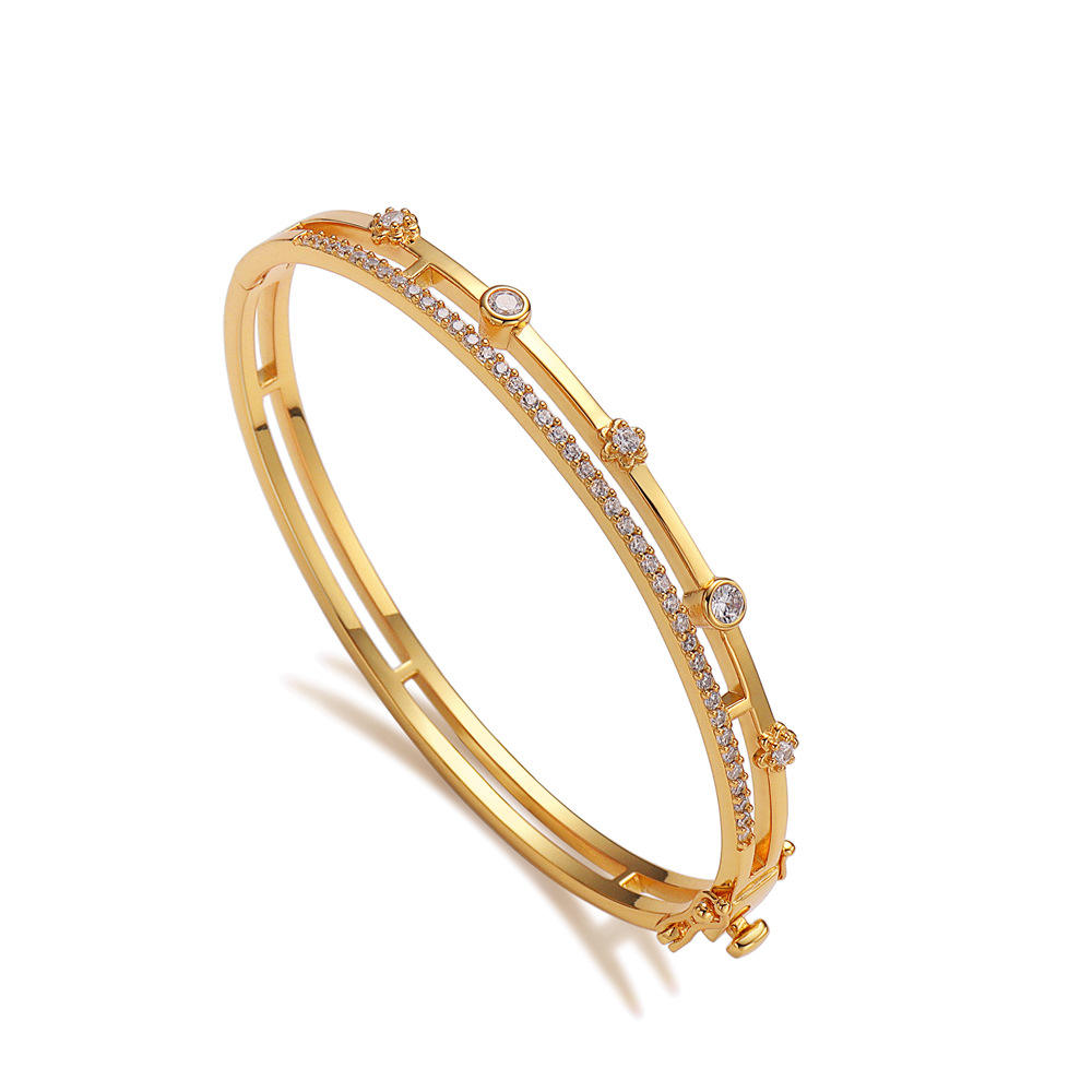 Gold inlaid with zircon