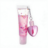 Best-seller transfrontalier : Brillant à lèvres effet miroir changeant de couleur, hydratant et repulpant, avec ornement suspendu en forme de coquille et de cœur