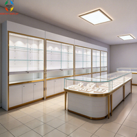 Vitrine à bijoux de luxe finition miroir dorée, étagères en verre réglables, éclairage LED, écologique, robuste, haut de gamme, boutique