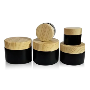 Tarros de vidrio personalizados con acabado mate esmerilado negro de 50g, 30g, 15g, 10g, <span class=keywords><strong>5g</strong></span>, 10ml, 20ml, 50ml con tapas de bambú con textura de madera. - Product Image 1