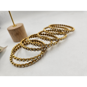 Traditional gold-plated daily wear <b>bangles</b> featuring a sleek circular design adorned with white stones <b>set</b> - Product Image 1
