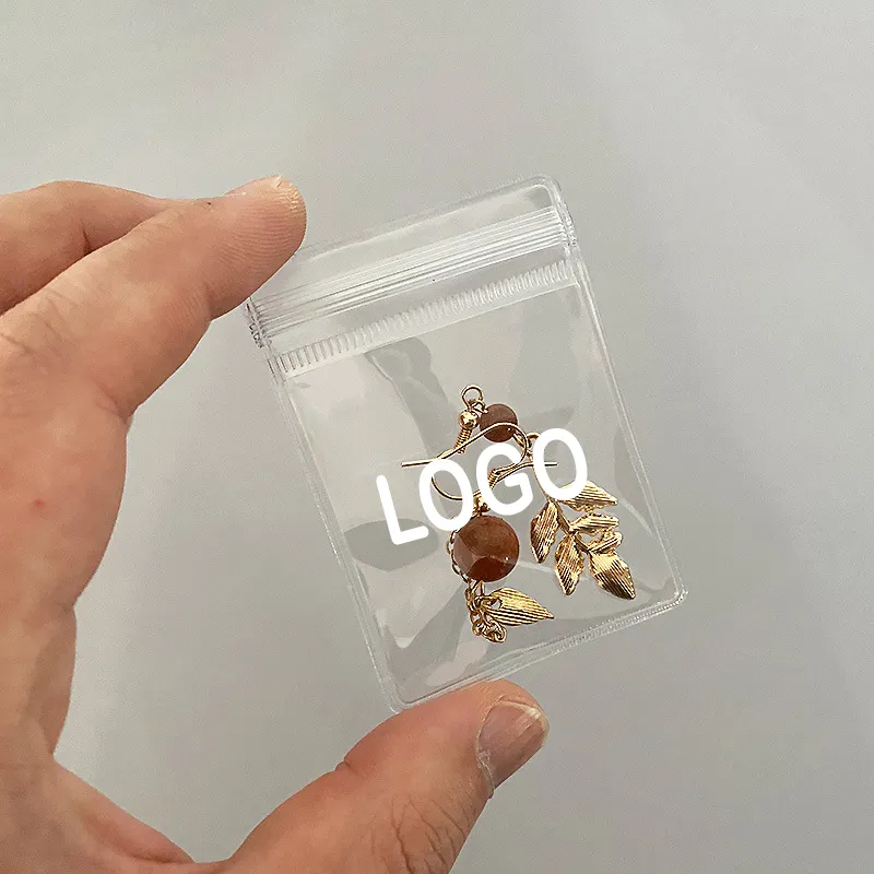 Emballage de bijoux personnalisé sacs en plastique avec logos pochette à bijoux transparente en PVC petit sac à fermeture éclair pour grandes boucles d'oreilles