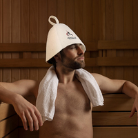 Un gorro de sauna de lana pura que porta el nombre de su marca como un distintivo de honor mientras que el calor se recede al otro lado de la puerta.