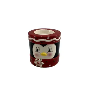 Ceramic penguin holding tealight candle holder