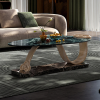 Table basse moderne de luxe en marbre vert, table centrale créative à base incurvée, table à thé sculpturale pour villa, hôtel, salon