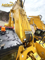 Excavatrice PC1250 8 d'occasion avec moteur de 775 CV, PLC et boîte de vitesses, modèle 2021, excellent état, livraison rapide