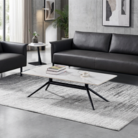 Table basse moderne en marbre blanc avec base araignée en métal noir élégante pour un bureau ou un salon minimaliste de luxe