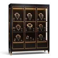 Luxuriöse Schwarz-Gold Schmuck-Vitrine Gebogene Glasvitrine Freistehende Verkaufsvitrine mit LED-Warmlicht
