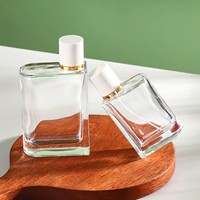 Bouteille de parfum en verre transparent rectangulaire unique de 100ml vide pour diffuseur de parfum pour femme avec pulvérisateur à pompe pour cadeau