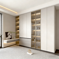 Armoire de chambre moderne personnalisée avec portes en MDF et structure en panneaux de fibres à haute densité pour le rangement et l'exposition dans le salon