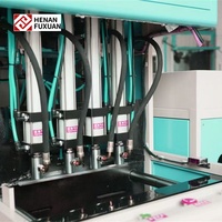 Nouvelle souffleuse de bouteilles PET semi-automatique Fuxuan à 4 cavités avec contrôle PLC et composants essentiels pompe/moteur 220V