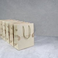 Sac en papier d'emballage cosmétique de luxe en gros avec poignée torsadée robuste et logo personnalisé