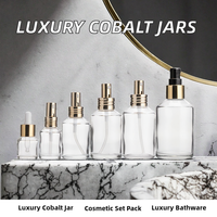 Vente en gros de flacons pulvérisateurs ronds en verre transparent avec pulvérisateur en aluminium doré pour l'emballage de parfums et de cosmétiques