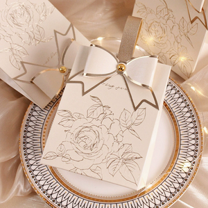 New cream-white <b>wedding</b> candy <b>box</b> with a retro French-style hand-held champagne-colored bow texture candy <b>box</b> design - Product Image 2