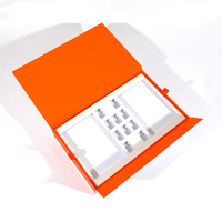 Boîte cadeau personnalisée de luxe en carton rigide orange en forme de livre avec insert en mousse EVA pour ensemble d'huiles essentielles cosmétiques