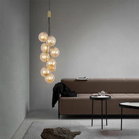 Lustre de luxe moderne en verre ambré à plusieurs têtes, en forme de globe, pour escalier en colimaçon, lampe suspendue longue verticale pour hall duplex, plafond haut, foyer