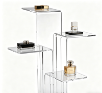 Support de présentation multi-niveaux en acrylique transparent avec plateformes escalonpées pour desserts, parfums et présentation de table de buffet de mariage
