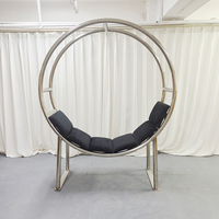Fauteuil moderne à double anneau en acier inoxydable avec coussin noir et structure circulaire pour événements et mariages