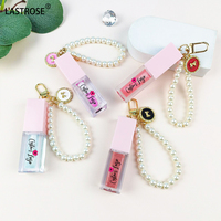 Nouveau design de soins rose dodu à base d'huile pour les lèvres filles fruits liquide brillant à lèvres baume à lèvres huile avec porte-clés