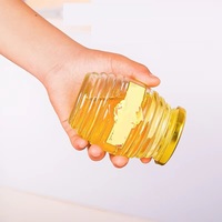Vente en gros de bouteilles de miel vides de 100g 250g 500g 1000g pots de miel en verre transparent en nid d'abeille avec couvercle en métal