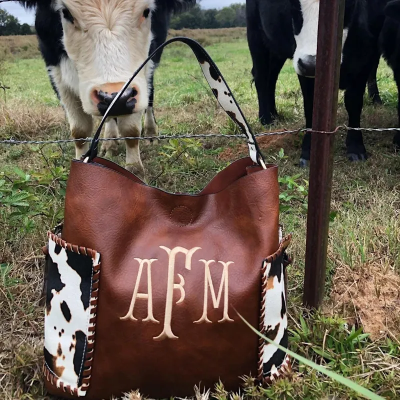 Bolsa monografada feminina de couro, bolsa grande e de mão com estampa de vaca