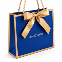 Sac cadeau de luxe bleu personnalisé avec logo, sac en papier écologique avec poignée en corde dorée pour boutique de bijoux et cosmétiques